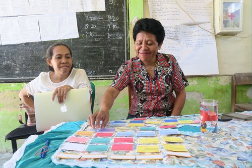 Two women engaged in a card sorting exercise for design research purposes. One is facilitating and one is participating.